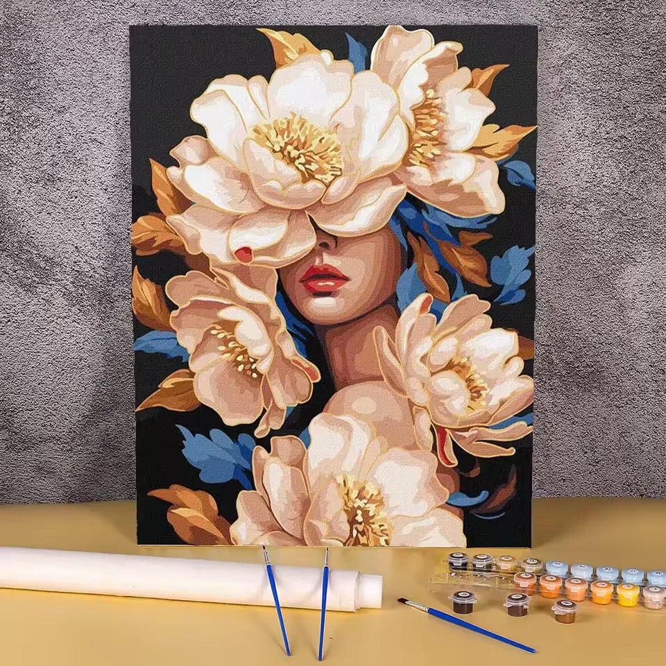 Paint by numbers kit of a woman surrounded by large cream and gold peonies against a dramatic dark background, 30x40cm